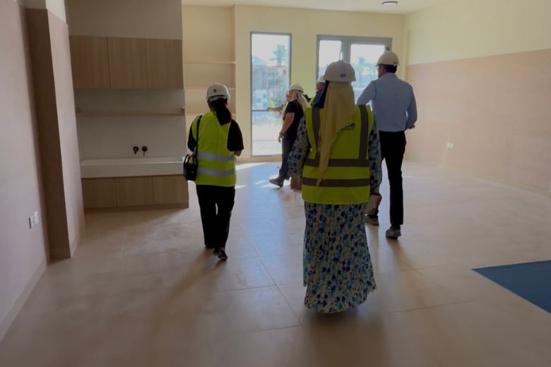 One of the school's nearly-finished classrooms, where warm tones, built-in wooden storage and carpet integrated into the floor already feel considered and calm.