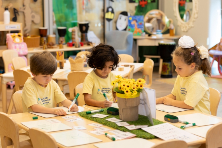 Children learning at their own pace in a classroom at Jumeirah International Nursery