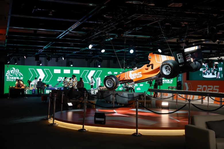 A student team proudly displays their custom-designed motorsport branding and technical portfolio